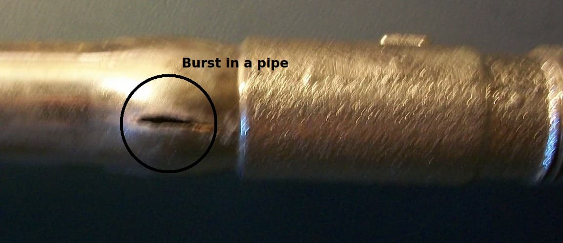 A burst copper pipe caused by freezing showing the split in the pipe wall